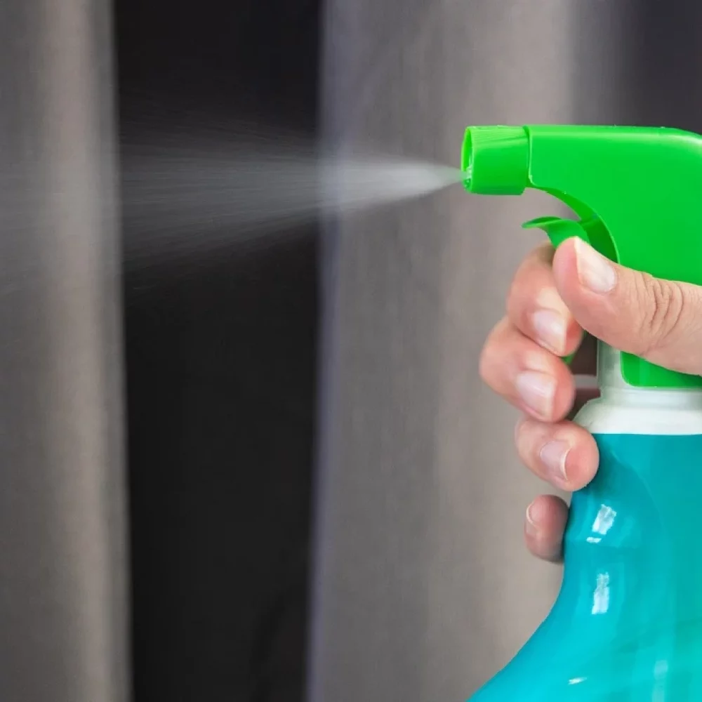 A cleaner disinfecting a surface